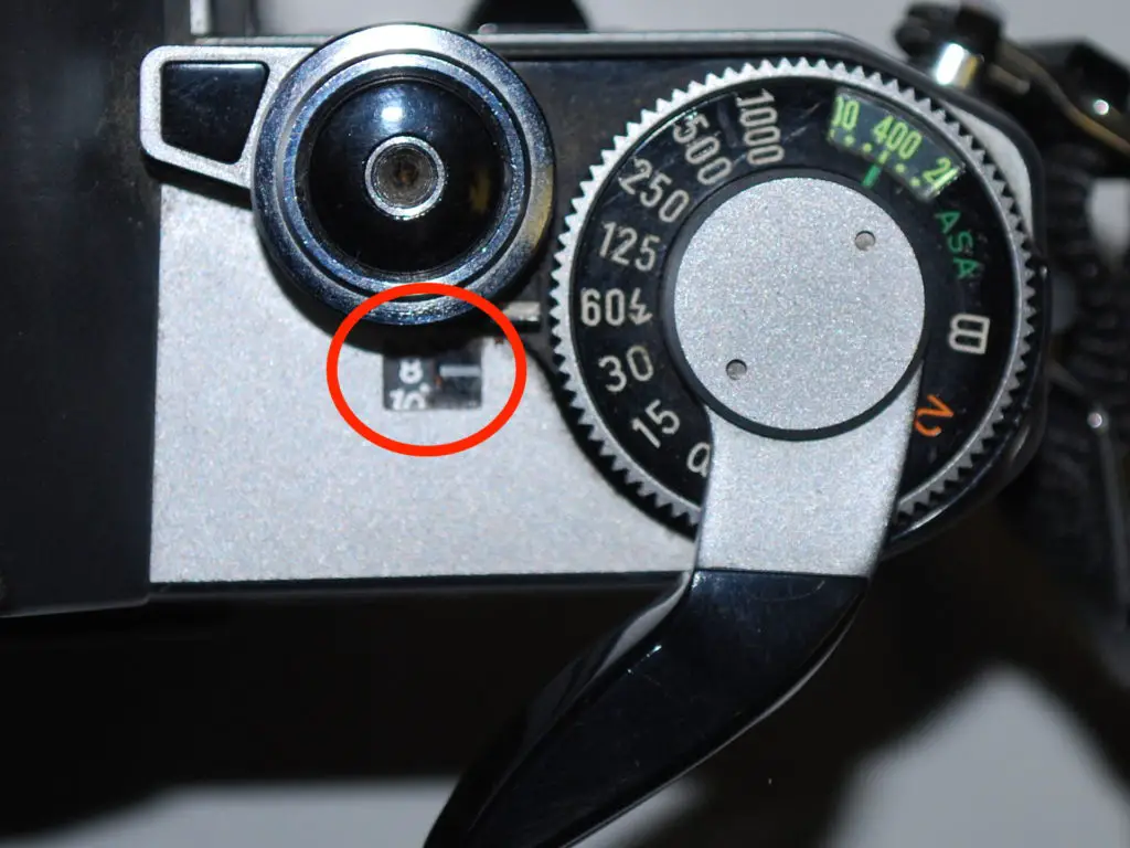 The frame counter (next to the film advance lever and shutter speed dial) on the Canon AE-1 that counts down your exposures