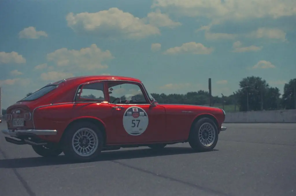 Image of a Red sports car on expired color film. You can see the limited contrast and dulling of the colors. 