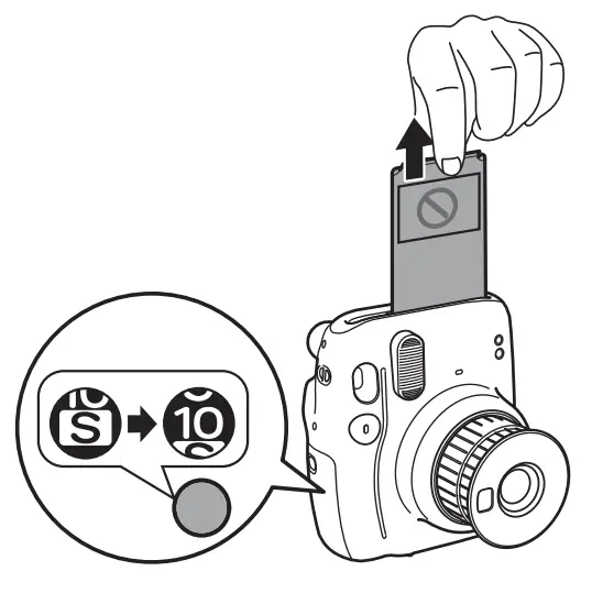 Instax Mini 11: Is It Worth Buying? 10 Ejecting the black paper film slide from the Instax Mini 11.