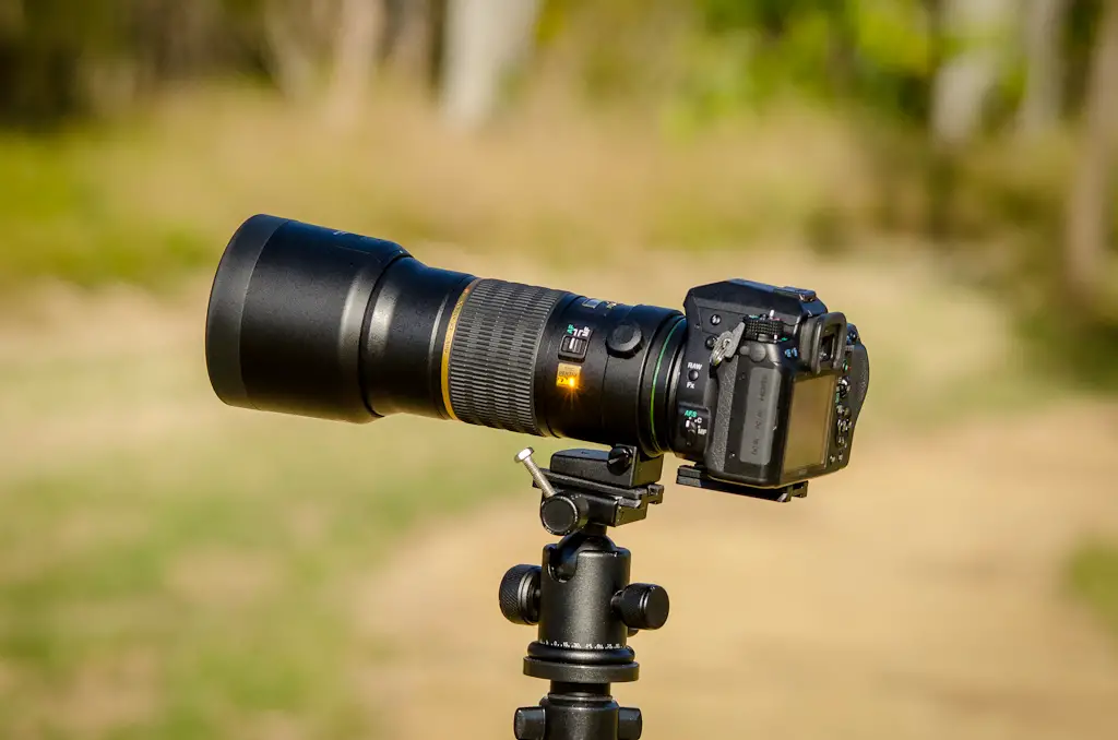 Camera with a Telephoto Lens on a Tripod For Stability