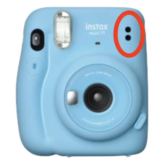 The two small holes used for calculating exposure on the Instax Mini 11.